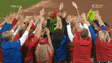 a group of people raising their hands in the air with nbc sports philadelphia on the bottom
