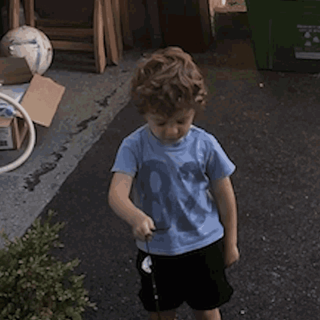 a young boy wearing a blue shirt with the number eight on it