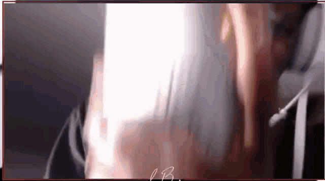 a close up of a person 's face with a microphone in a dark room .