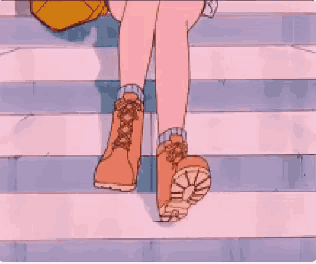 a person is walking down a set of stairs wearing timberland boots .