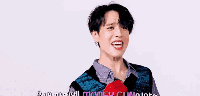 a young man is holding a bunch of money in his hand .