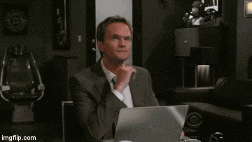 a man in a suit and tie is sitting at a desk with a laptop ..