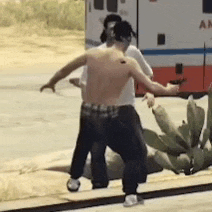 a man without a shirt is standing next to another man holding a gun .