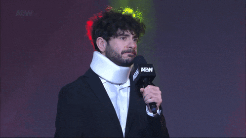 a man wearing a neck brace is holding a microphone that says abw on it