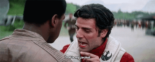 two men are standing next to each other and one of them is pointing at the other and saying `` that 's my jacket . ''