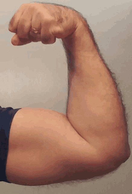 a man 's arm with a ring on it