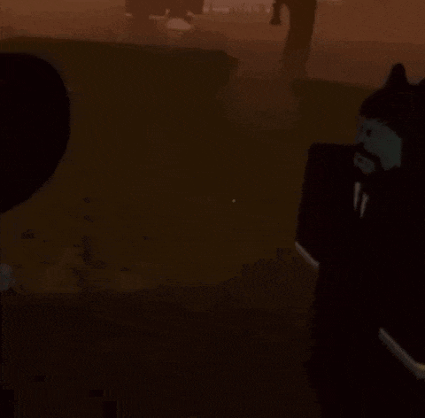 a man in a suit and tie is standing in a dark room holding a gun .