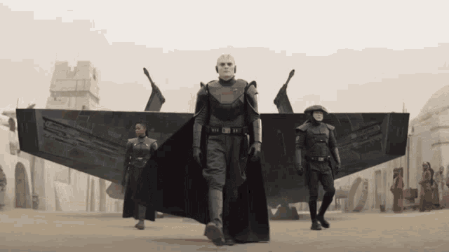 a man with a skull on his head walks with two other men