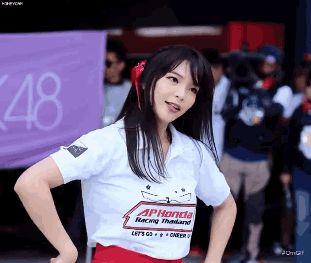a woman wearing a shirt that says aphonda racing thailand