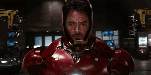 a close up of a person wearing a red and gold iron man suit