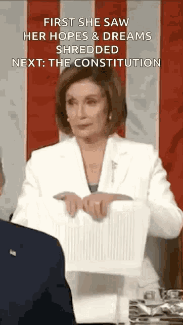 a woman is holding a piece of paper in front of a man .