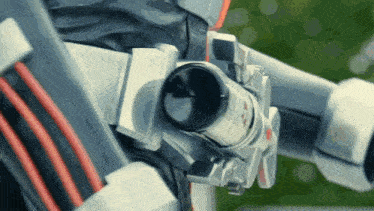 a close up of a metal object with a red and white stripe on it