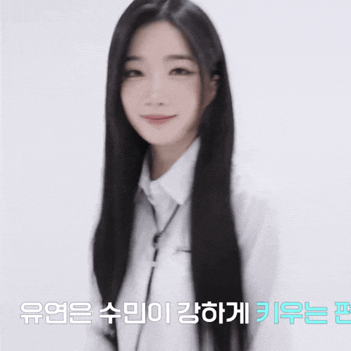 a woman with long black hair is smiling with a foreign language behind her