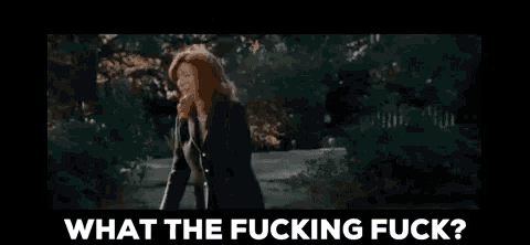a woman is being sprayed with water and the words `` what the fucking fuck '' are below her .