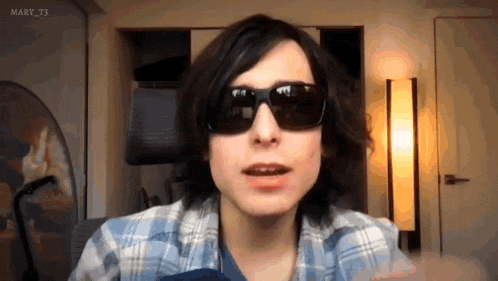 a woman wearing sunglasses and a plaid shirt with the hashtag mary_t3 on the bottom right