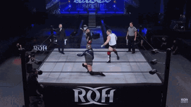 two wrestlers in a ring with the word roh on the side
