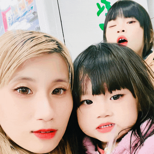 a woman and two young girls pose for a picture