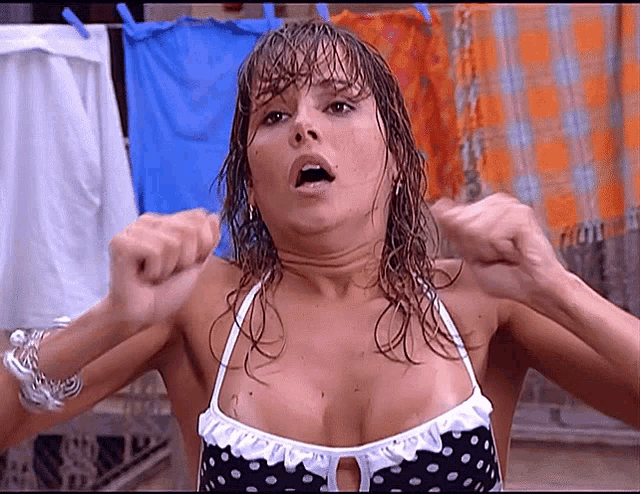 a woman in a polka dot bikini is making a face