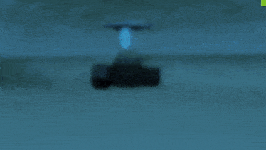 a blurred image of a black object with a white arrow pointing to the left