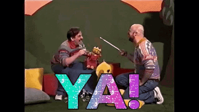 two men are playing with stuffed animals and the word ya is visible in the foreground