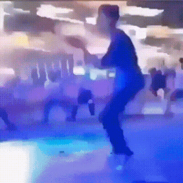 a blurry image of a person dancing in a room