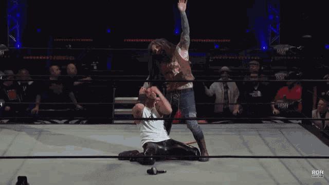 a wrestling match is being shown on a screen that says rgh on it