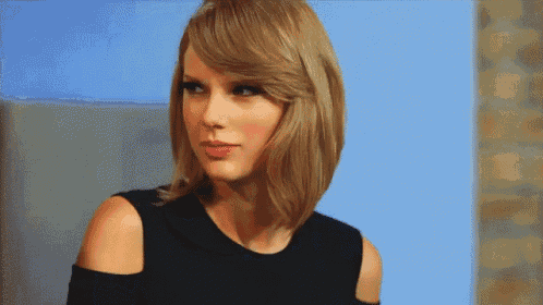 a woman with blonde hair is wearing a black dress