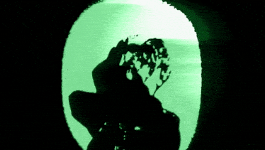 a green background with a black circle in the center