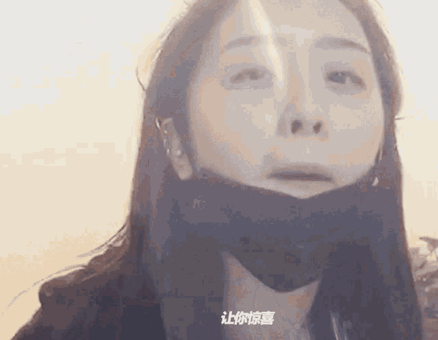 a woman wearing a black mask with chinese writing on her face