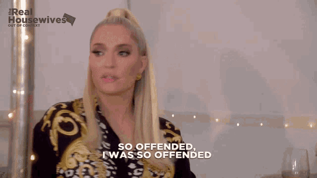 a woman says " so offended i was so offended " while wearing a black and gold shirt