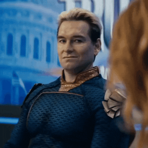 a man in a blue suit is smiling and looking at another man