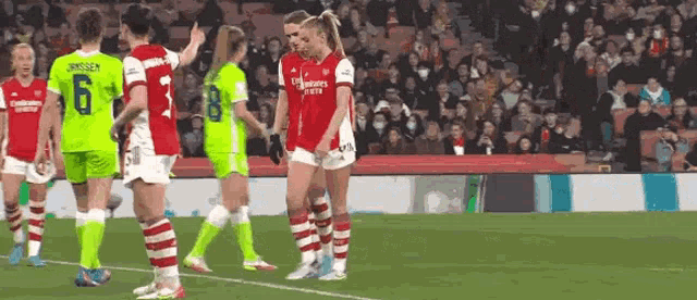 a group of women playing soccer on a field .