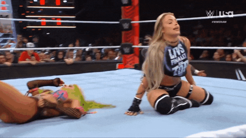 two women in a wrestling ring with one wearing a shirt that says ' liv 's finally on top ' on it