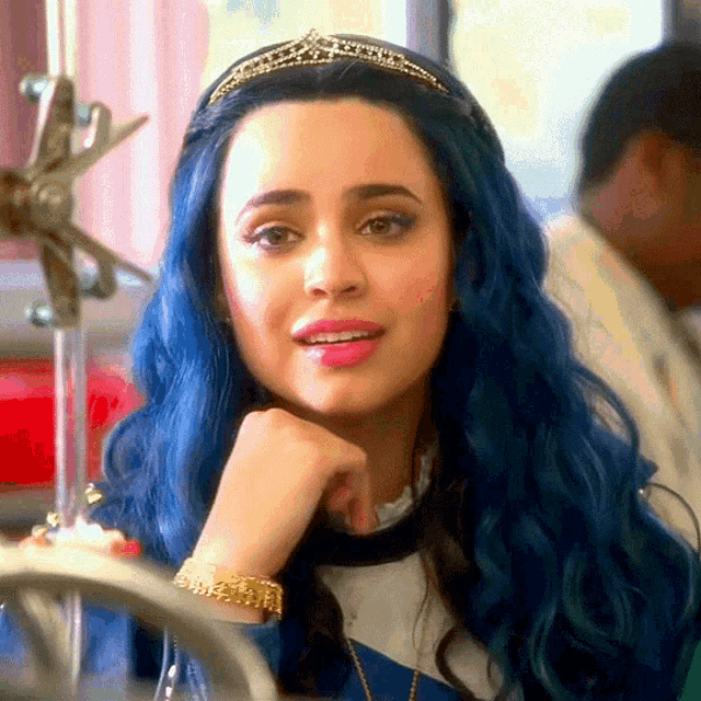 a woman with blue hair wearing a tiara