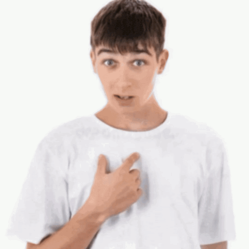 a young man wearing a white shirt is smiling and making a fist