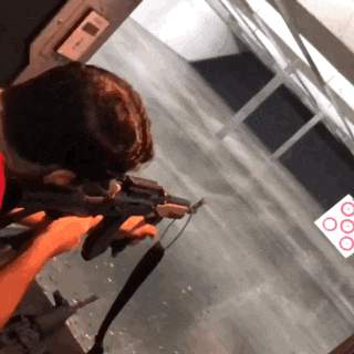 a person is holding a gun in front of a sign that says ' 00 '