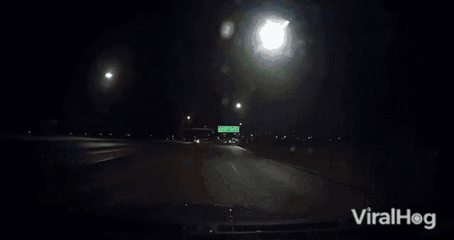 a car is driving down a highway with the words viralhog on the bottom right