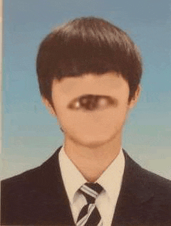 a man in a suit and tie has an eye in his face .
