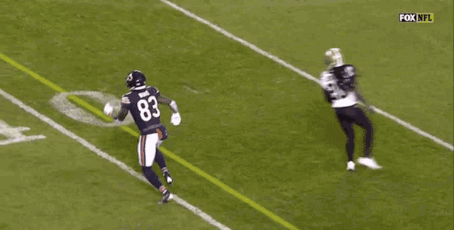 a football player with the number 2 on his jersey is being tackled by another player