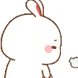 a white rabbit is holding a book in its hand and blowing smoke .