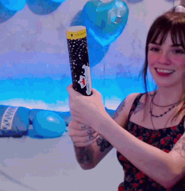 a woman holding a confetti cannon with a sticker on it that says ' confetti cannon '