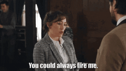 a woman in a suit says " you could always fire me " to a man in a suit