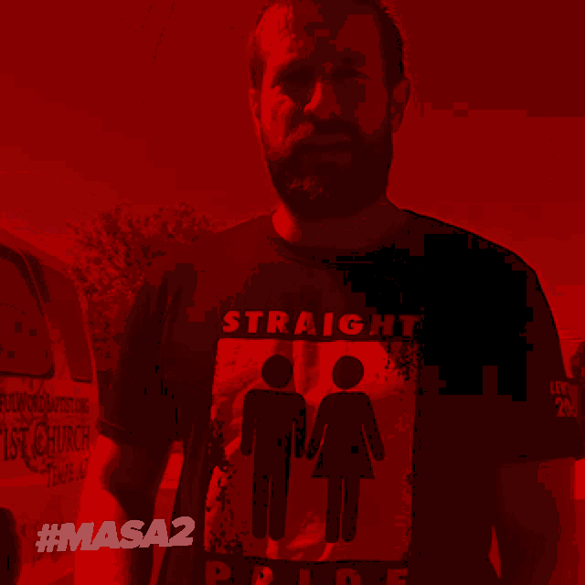 a man wearing a black shirt that says straight