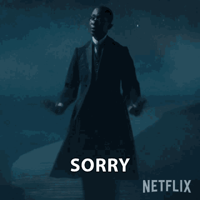 a man in a suit says sorry in front of a netflix logo