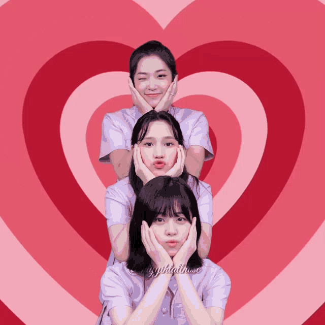 three girls making faces in front of a pink heart