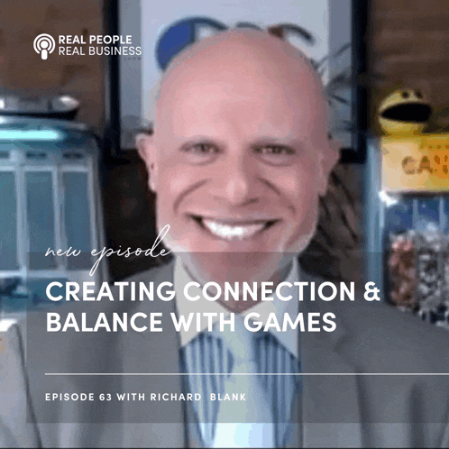 a man in a suit and tie is smiling for a real people real business episode