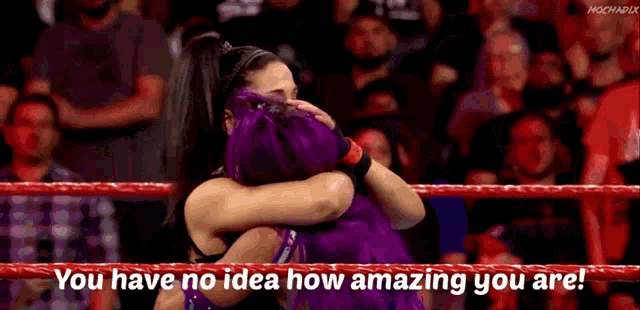two women hugging in a wrestling ring with the words `` you have no idea how amazing you are ''