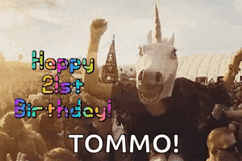 a man wearing a unicorn mask is standing in front of a crowd .