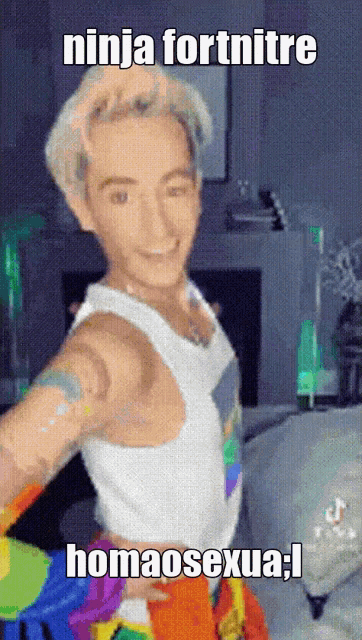 a man in a white tank top has a rainbow colored shirt on
