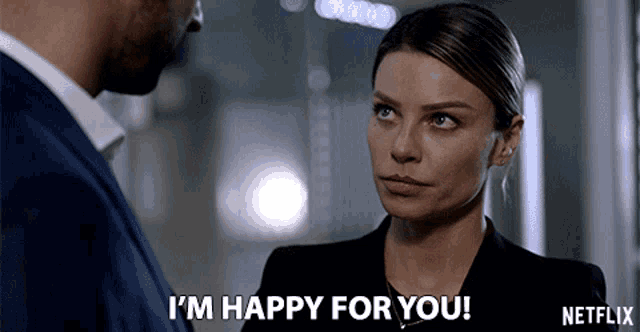 a woman says i 'm happy for you while looking at a man in a suit